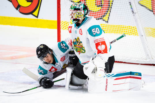 Patryk Wronka and goalkeeper Shane Owen of Belfast looks