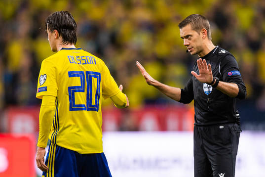 Kristoffer Olsson of Sweden in a discussion with referee