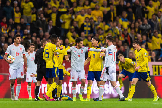 Dani Ceballos of Spain goes in between Fabian Ruiz and