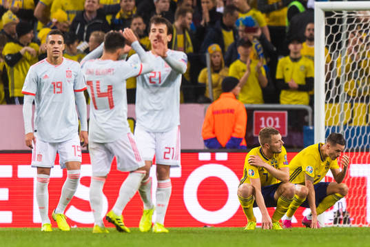 Sebastian Larsson and Mikael Lustig of Sweden look dejected