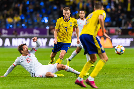 Mikel Oyarzabal of Spain tackles Sebastian Larsson of Sweden