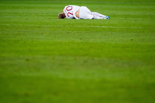 Martin Ødegaard of Norway lies down with an injury