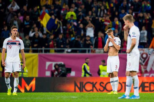 Markus Henriksen and Kristoffer Ajer of Norway look dejected