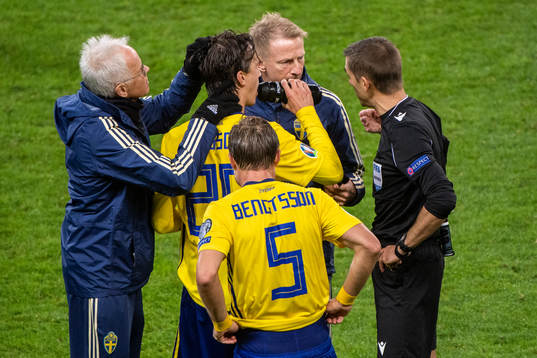 Kristoffer Olsson of Sweden receives medical attention