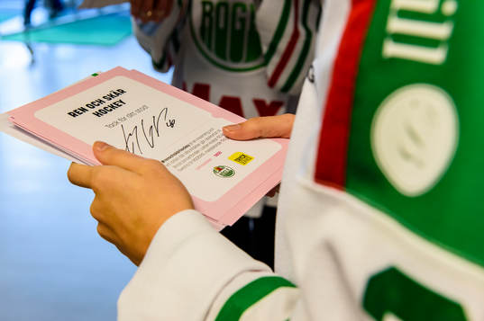 Försäljning av rosabandet lotter innan ishockeymatchen i