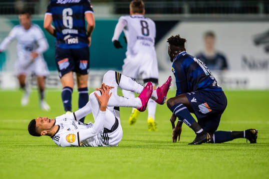 Bjørn Maars Johnsen of Rosenborg in pain and Aliou Coly of