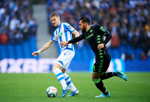 Martin Odegaard of Real Sociedad battles for the ball with