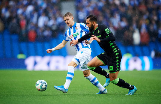 Martin Odegaard of Real Sociedad battles for the ball with