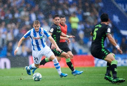 Martin Odegaard of Real Sociedad battles for the ball with