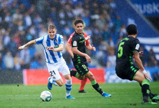 Martin Odegaard of Real Sociedad battles for the ball with