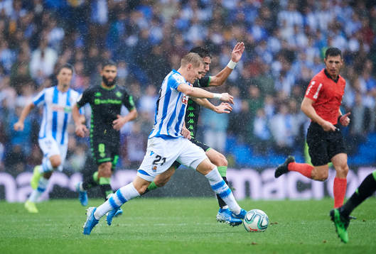 Martin Odegaard of Real Sociedad battles for the ball with
