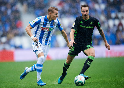 Martin Odegaard of Real Sociedad battles for the ball with