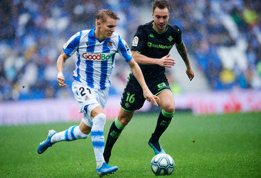 Martin Odegaard of Real Sociedad battles for the ball with