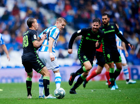 Martin Odegaard of Real Sociedad battles for the ball with