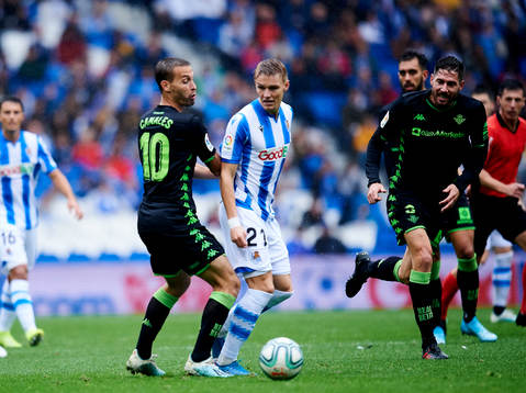 Martin Odegaard of Real Sociedad battles for the ball with