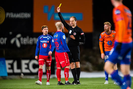 Andreas Løvland of Tromsdalen gets a yellow card by Jan