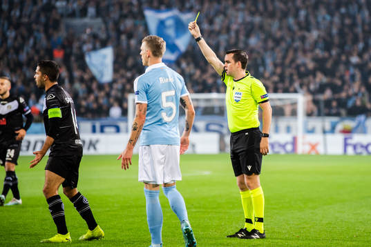 Mattia Bottani of Lugano receives a warning from referee