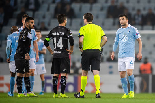 Behrang Safari of Malmö FF receives a varning from referee