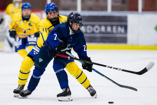 Sveriges Linnea Johansson i kamp om pucken med Finlands