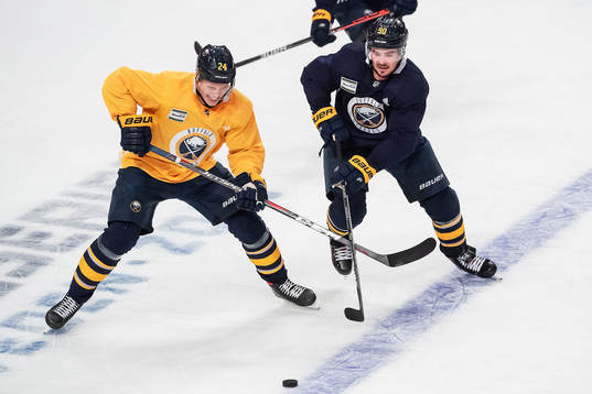 Lawrence Pilut and Marcus Johansson of Buffalo Sabres