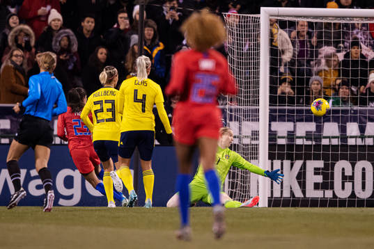 Christen Press of USA scores 2-0 behind goalkeeper Hedvig