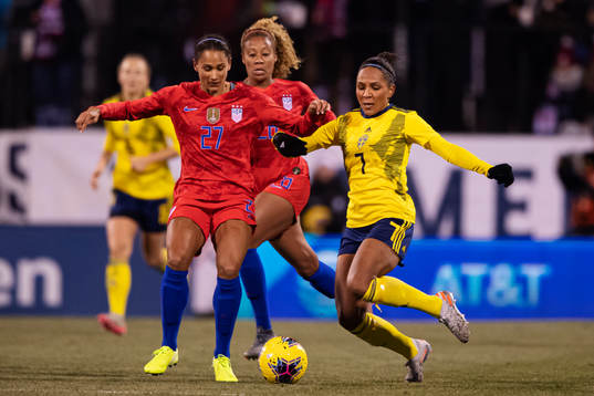 Lynn Williams and Allie Long of USA in action against