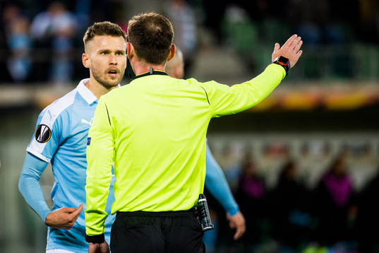 Arnor Traustason in discussion with referee Giorgi