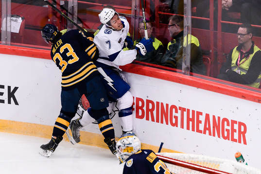 Colin Miller of Buffalo Sabres hits Mathieu Joseph of Tampa