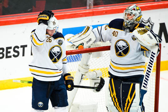 Rasmus Dahlin and goalkeeper Carter Hutton of Buffalo