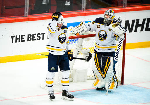 Rasmus Dahlin and goalkeeper Carter Hutton of Buffalo