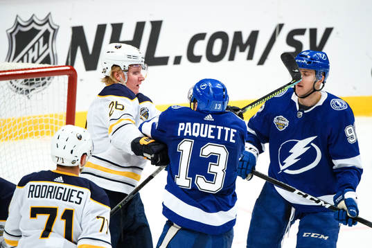 Rasmus Dahlin of Buffalo Sabres fights Cédric Paquette of