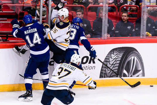 Rasmus Dahlin of Buffalo Sabres gets hit by Patrick Maroon