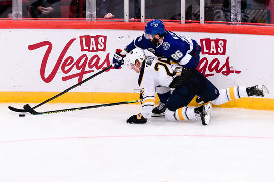 Rasmus Dahlin goes down in a battle with Nikita Kucherov of