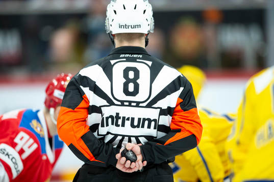 Referee holds the puck