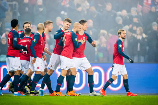 Tore Reginiussen of Norway celebrates with teammates
