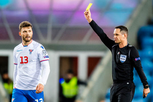 Rogvi Baldvinsson of Faroe Islands gets a yellow card from