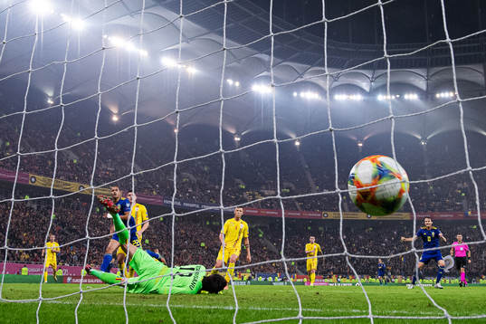 Robin Quaison of Sweden scores 0-2 behind goalkeeper