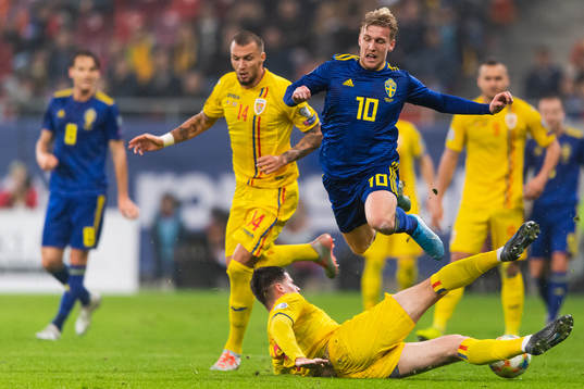 Emil Forsberg of Sweden is tackled by Tudor Baluta of