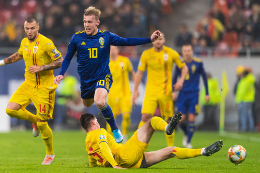 Emil Forsberg of Sweden is tackled by Tudor Baluta of
