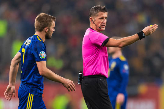Referee Daniele Orsato signs for Sebastian Larsson of