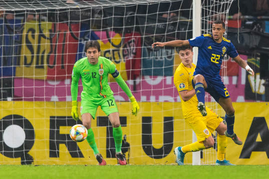 Goalkeeper Ciprian Tatarusanu of Romania and Robin Quaison
