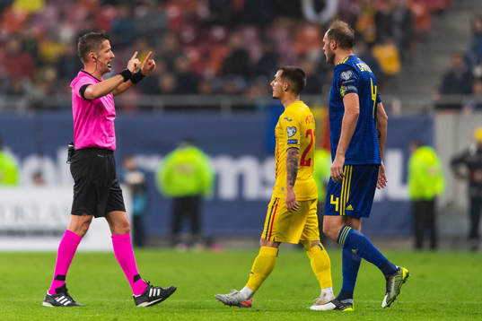 Referee Daniele Orsato in a discussion with Andreas