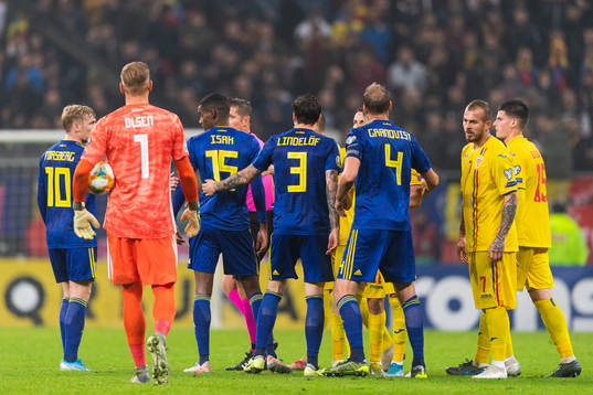 Referee Daniele Orsato in a discussion with Emil Forsberg,