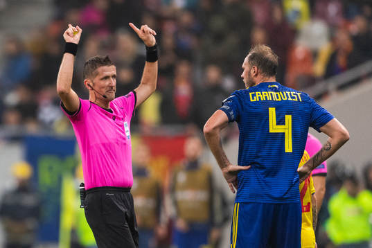 Referee Daniele Orsato in a discussion with Andreas