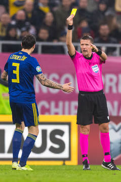 Victor Nilsson Lindelöf of Sweden receives a yellow card