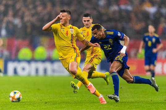 Adrian Rus of Romania and Robin Quaison of Sweden compete