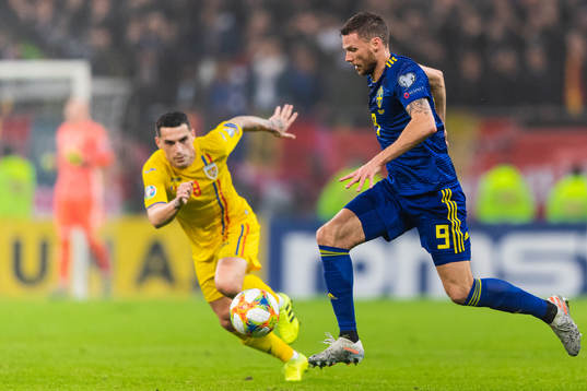 Nicolae Stanciu of Romania and Marcus Berg of Sweden