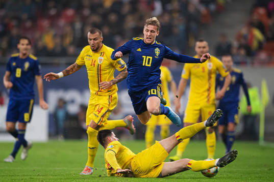 Emil Forsberg of Sweden is tackled by Tudor Baluta of