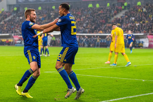 Sebastian Larsson and Robin Quaison of Sweden celebrate 0-2