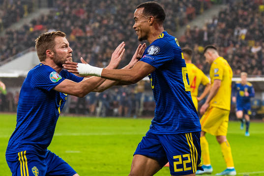 Sebastian Larsson and Robin Quaison of Sweden celebrate 0-2